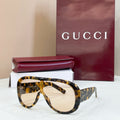 Gucci oversized tortoiseshell sunglasses with light beige lenses and dark temples