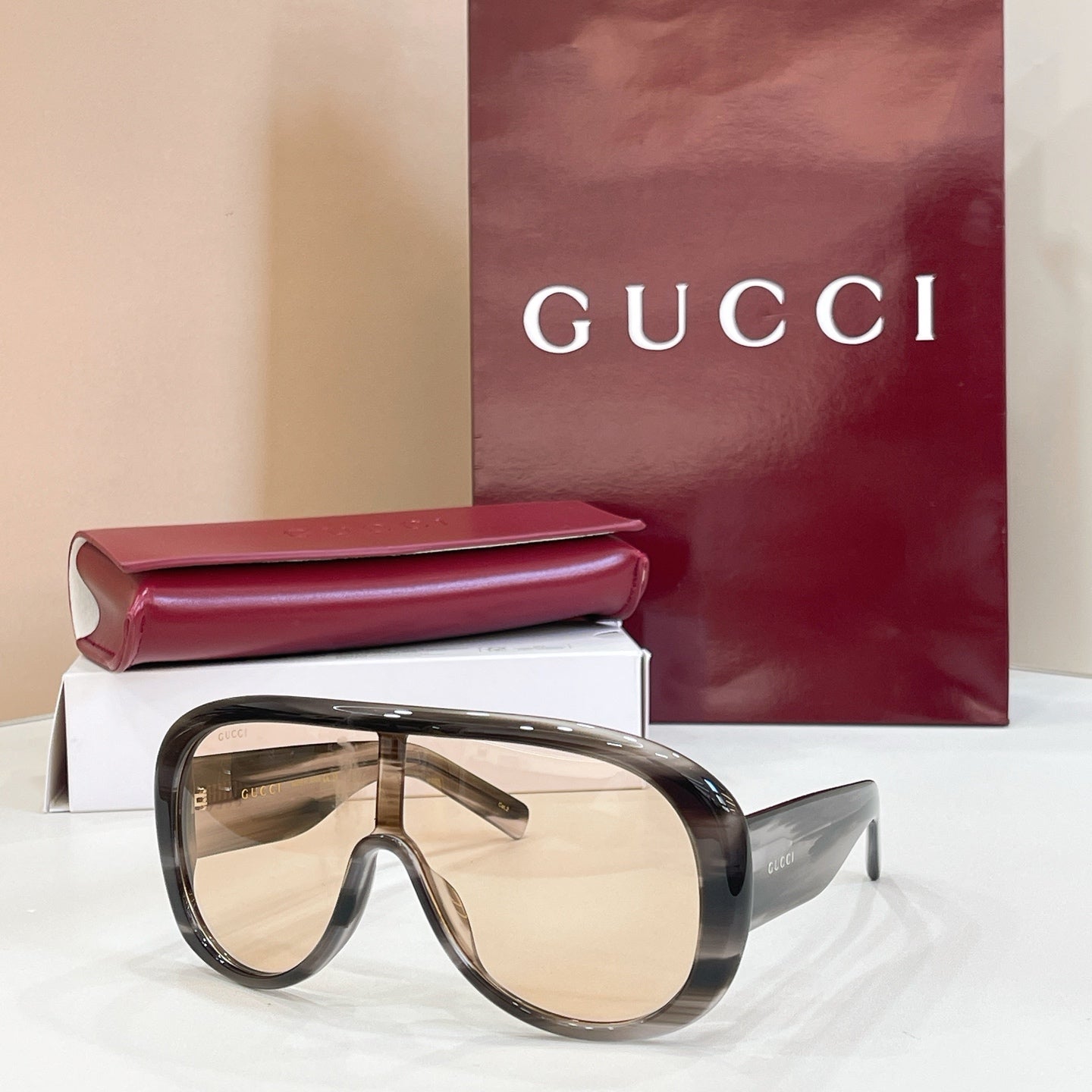 Gucci oversized dark tortoiseshell sunglasses with light beige lenses and angled temples
