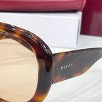 Tortoiseshell sunglasses close-up with Gucci logo on the temple arm
