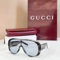 Dark tortoiseshell sunglasses with clear lenses and curved full-rim frame