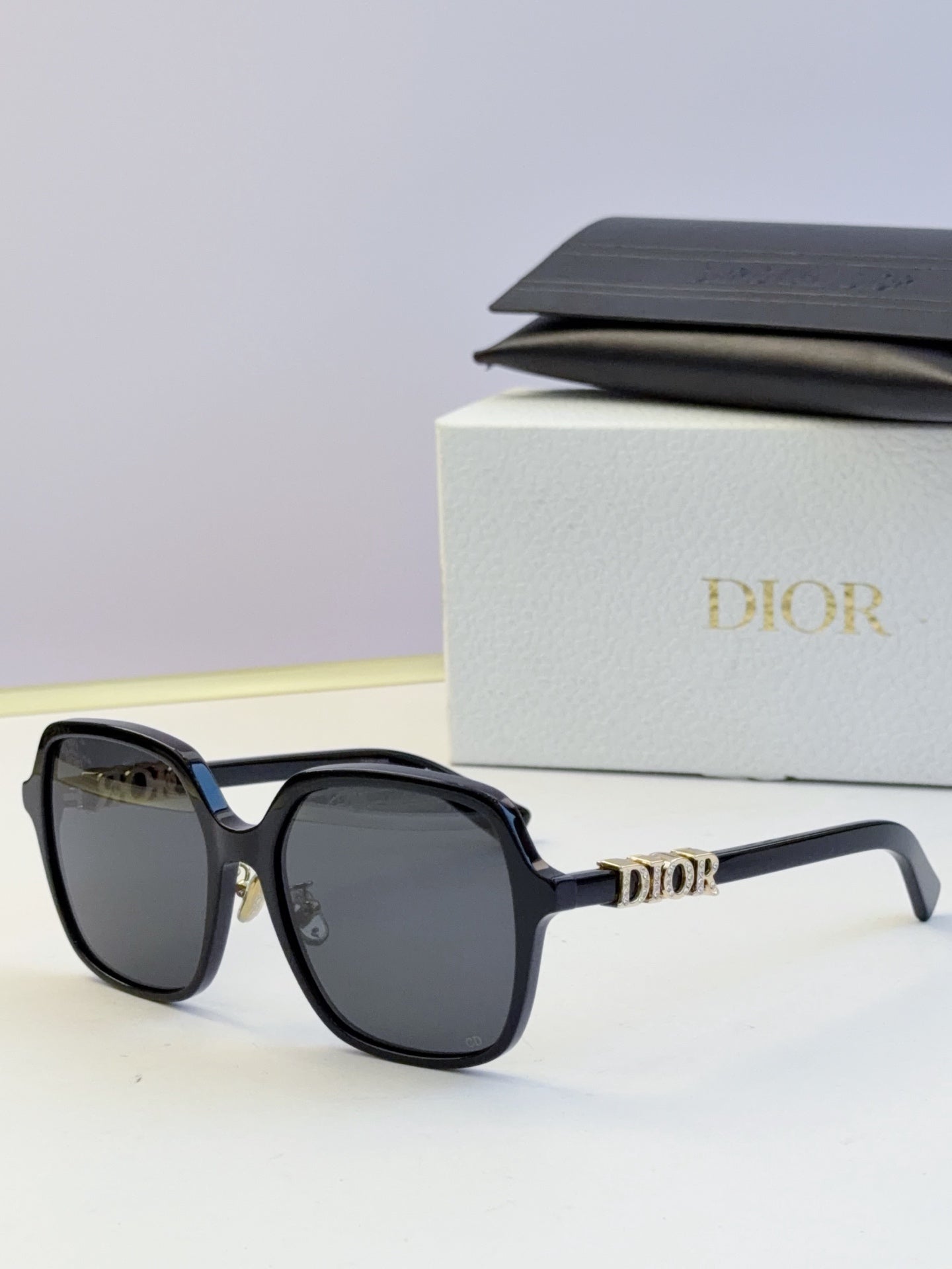Dior black square sunglasses with gold logo detailing on the temples