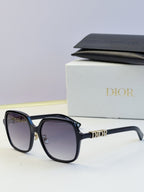 Dior black round sunglasses with gold hinge and “Dior” temple logo
