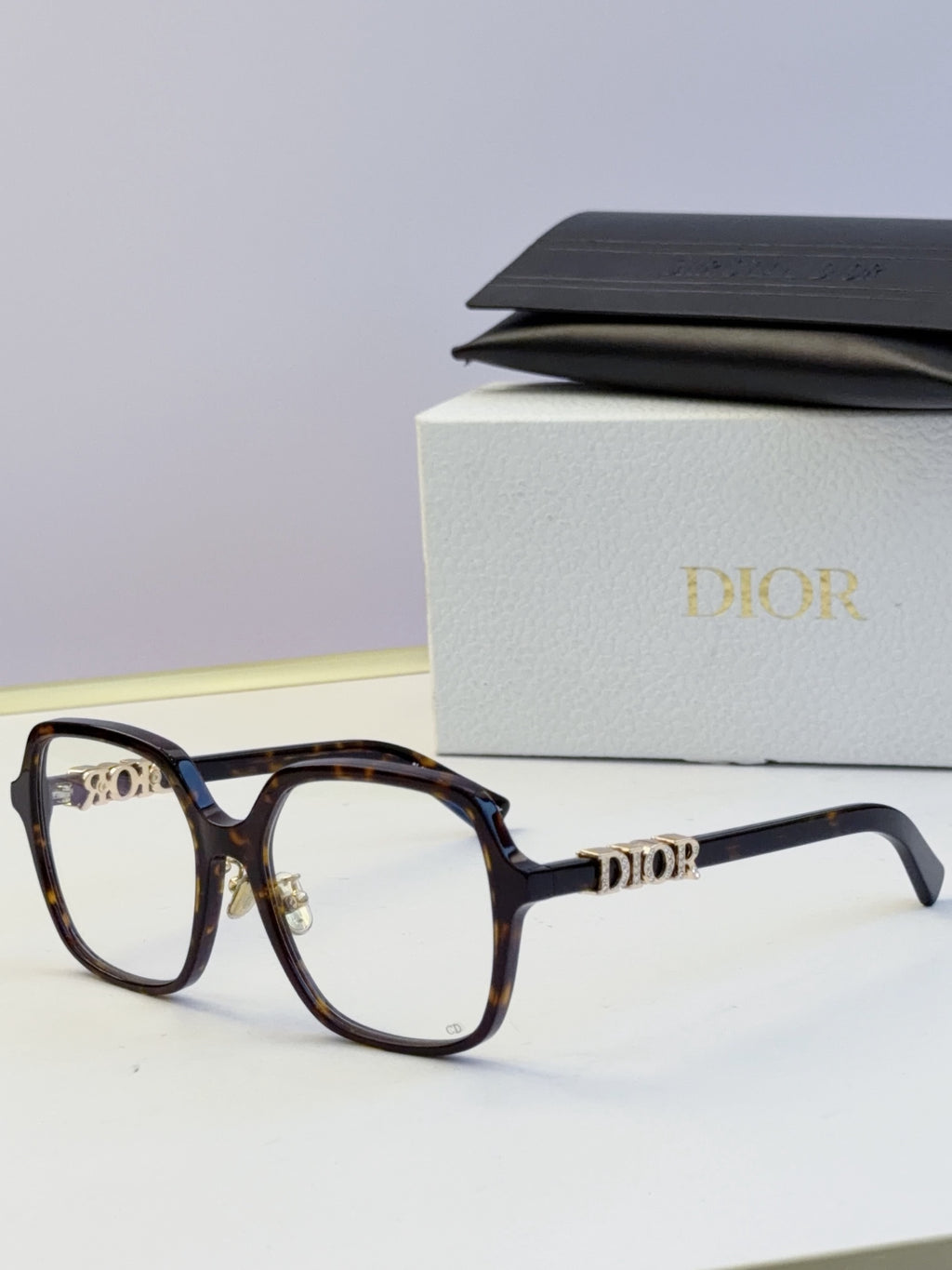 Dior dark tortoise eyeglasses frames with gold “Dior” logo on temples