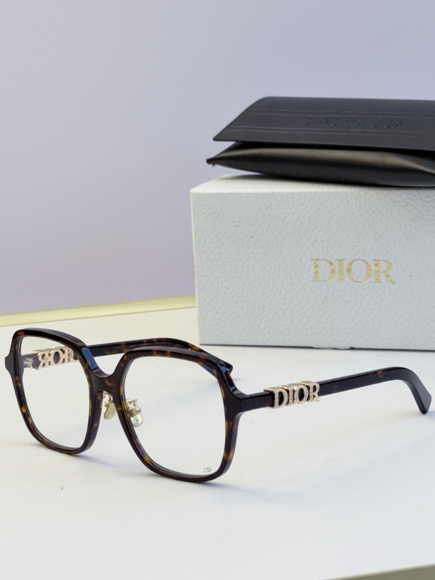 Dior dark tortoise eyeglasses frames with gold “Dior” logo on temples