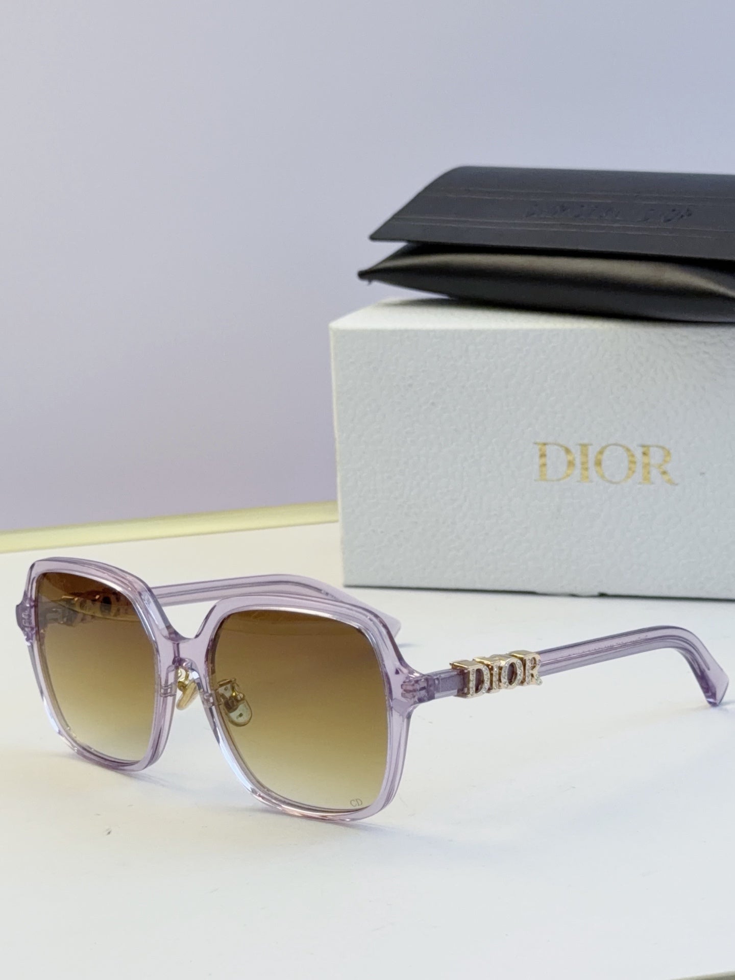Dior lilac square sunglasses with gold “Dior” logo on the temples