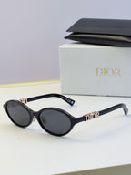 Dior round eyeglasses with black frame, dark lenses, and gold logo temples