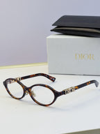 Dior round eyeglasses with tortoiseshell frame, amber lenses, and gold logo