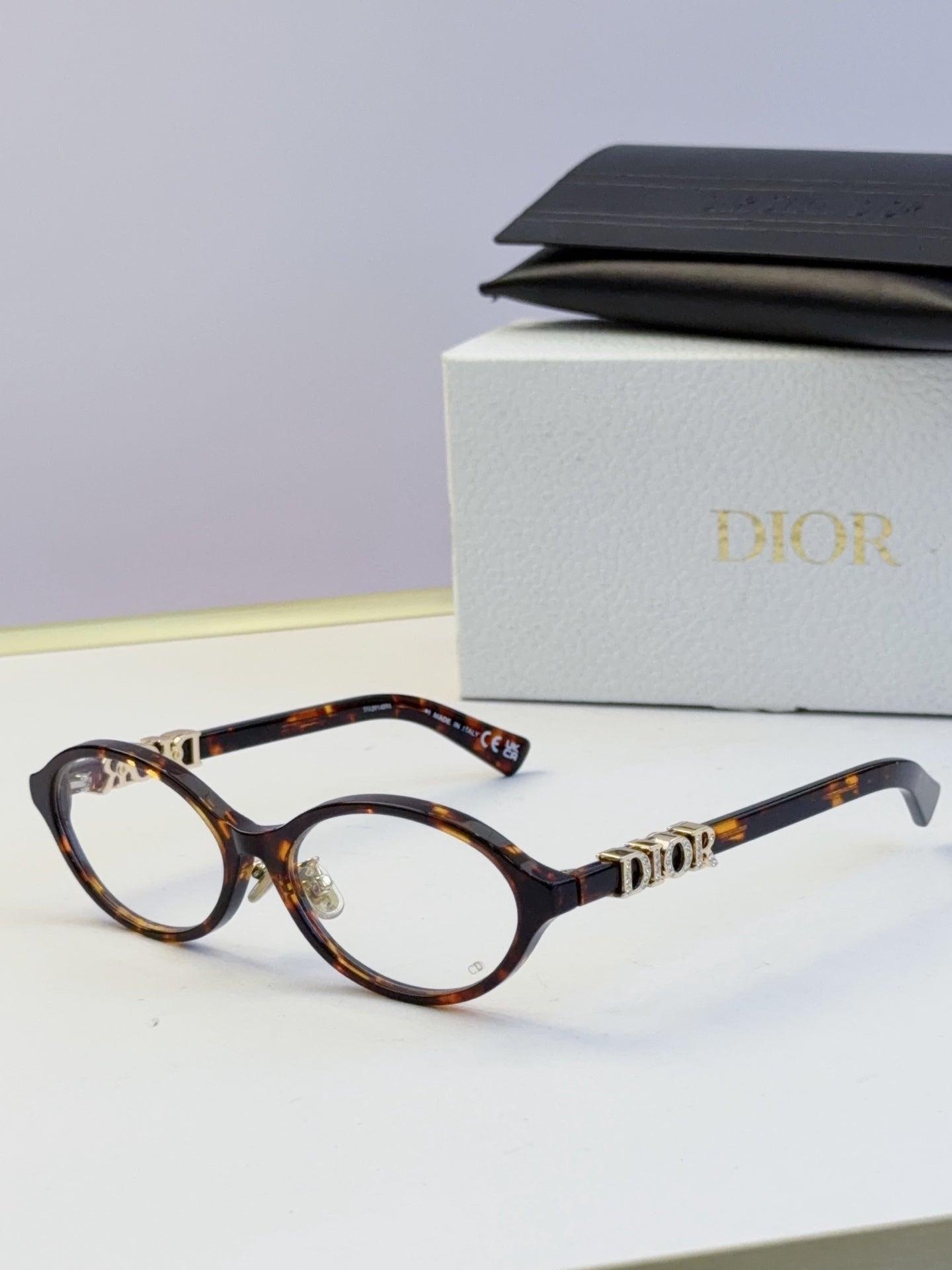 Dior round eyeglasses with tortoiseshell frame, amber lenses, and gold logo