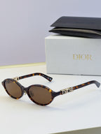 Dior round eyeglasses with tortoiseshell frame, brown lenses, and gold logo