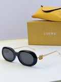 Black round sunglasses with gold-tone metal hinges and dark tinted lenses