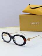 Black round sunglasses with gold-tone hinges and tortoiseshell temple accents