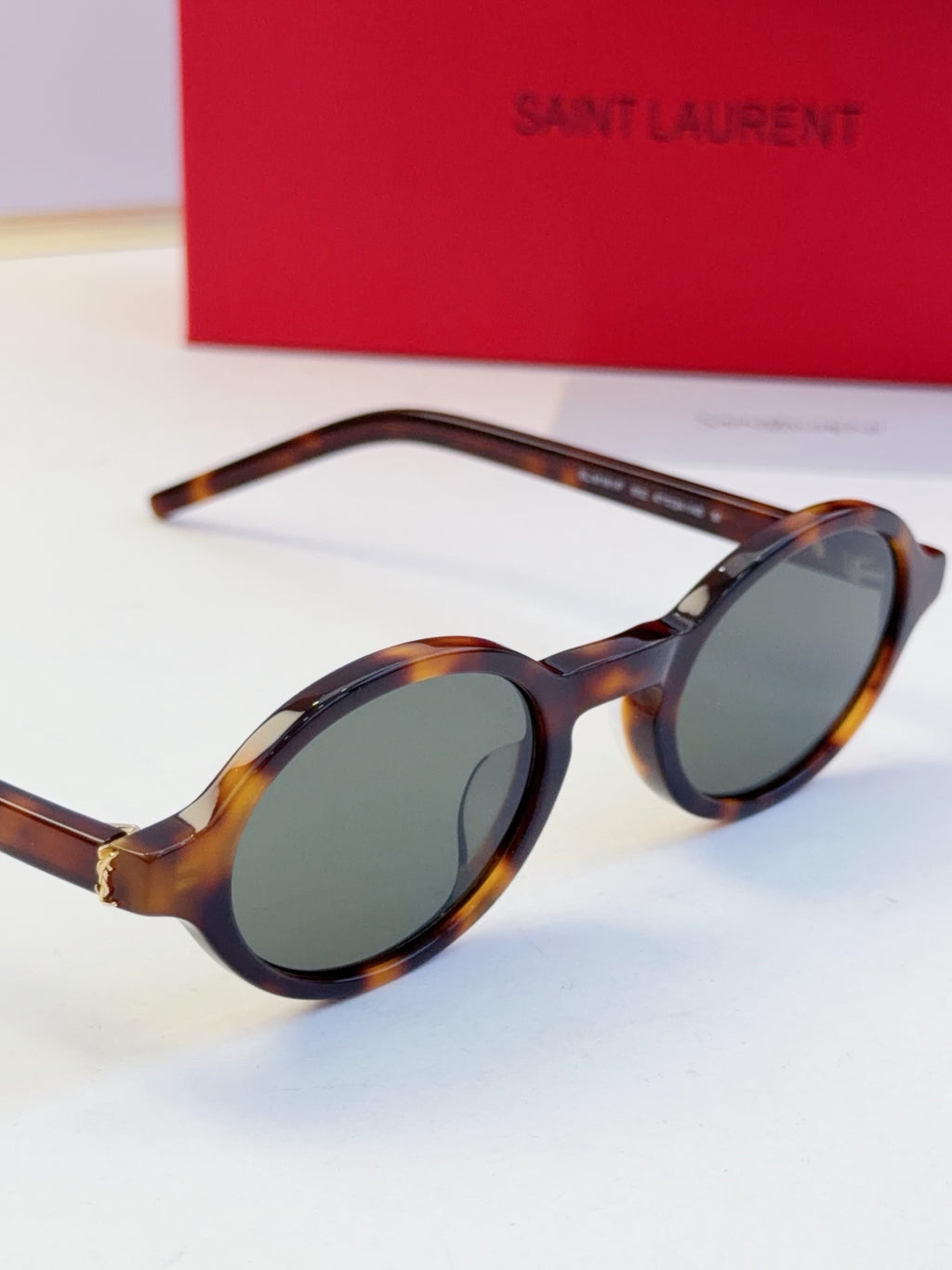 YSL round sunglasses with dark lenses and tortoise-pattern frame, side angle