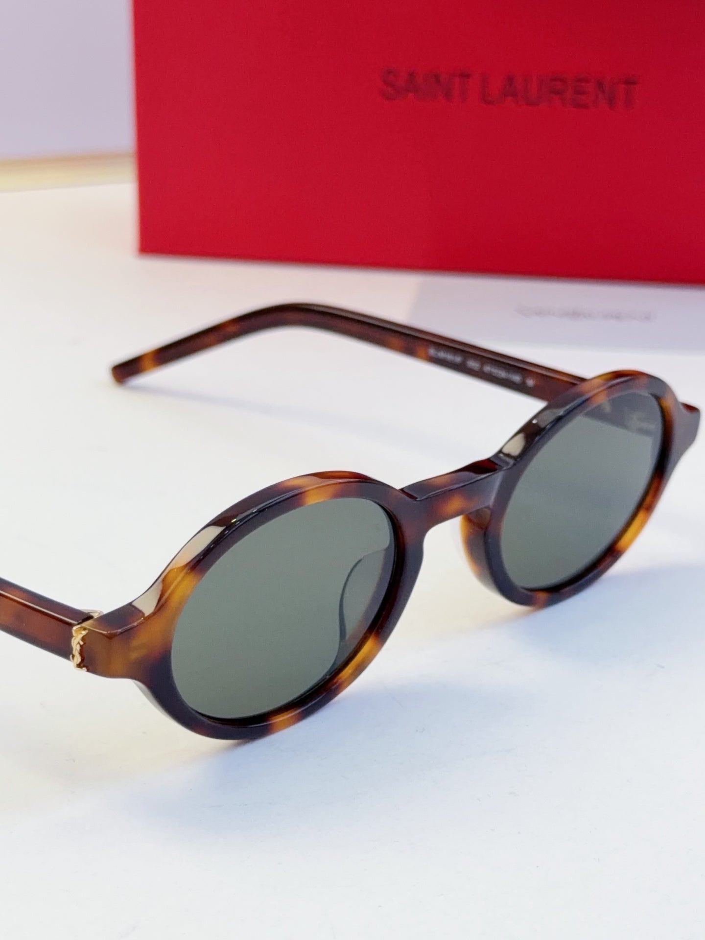 YSL round sunglasses with dark lenses and tortoise-pattern frame, side angle