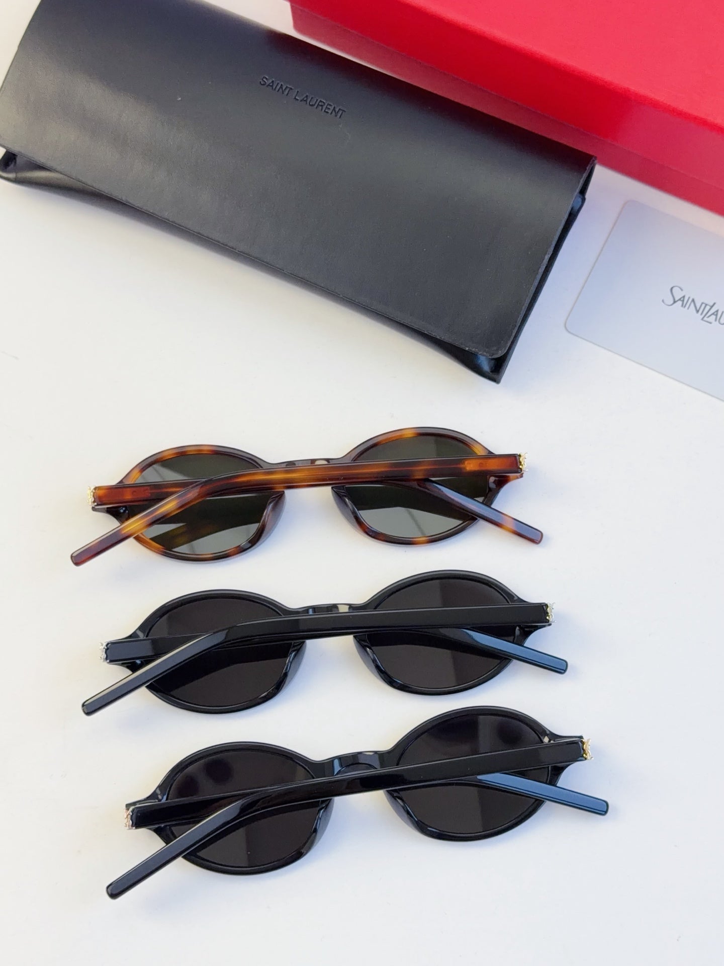 Set of YSL round sunglasses: tortoise and two dark pairs with oval lenses