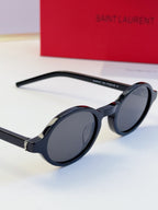 YSL round sunglasses side view with dark lenses and dark frame, gold hinge detail