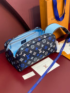 Louis Vuitton bag with black-blue monogram and light blue interior, open top zip.
