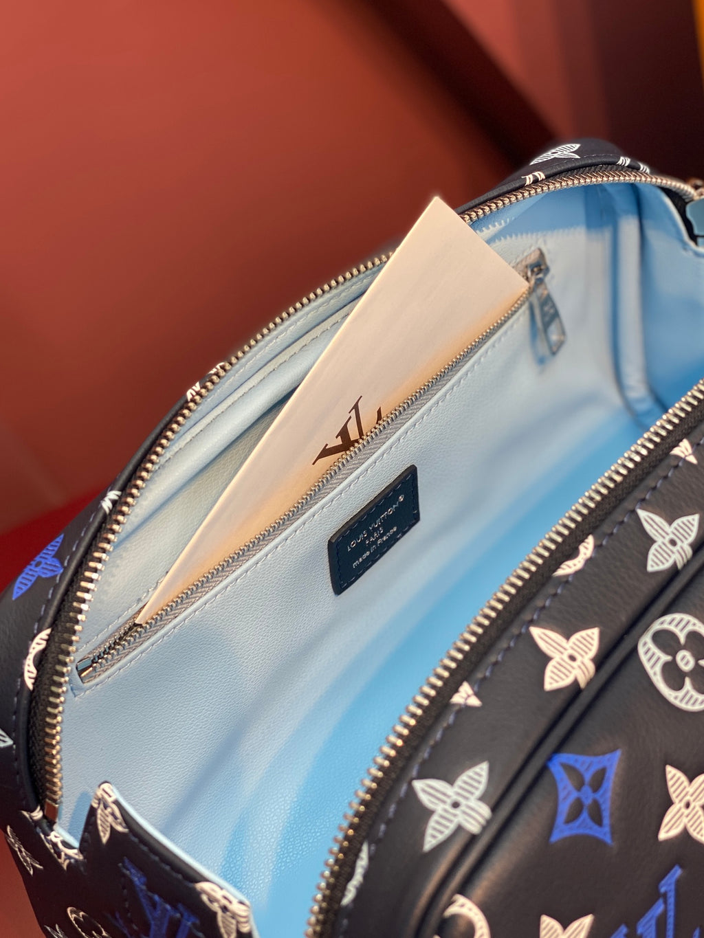 Louis Vuitton bag interior close-up, light blue lining and zip pocket inside.
