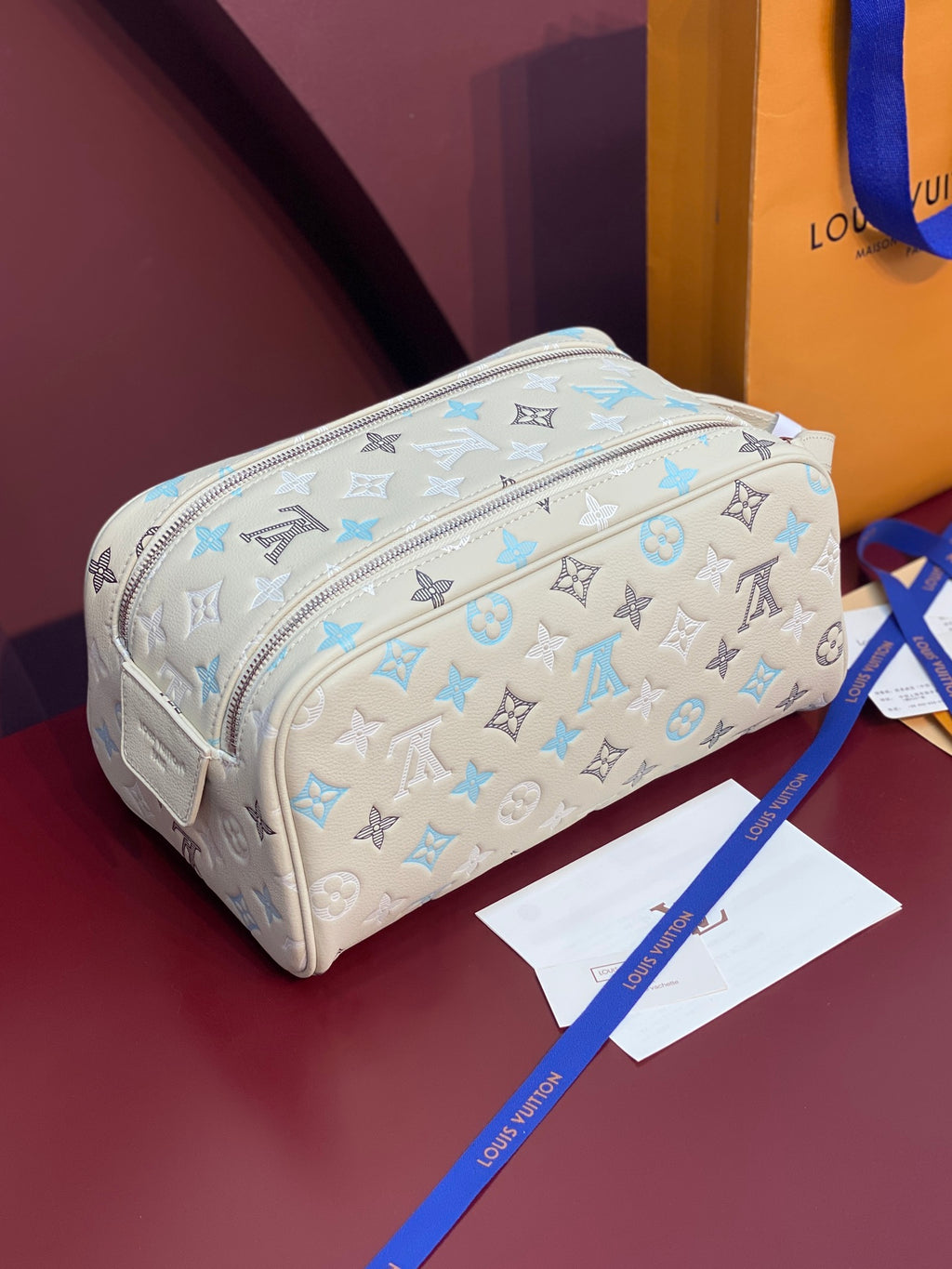 Louis Vuitton monogram cosmetic bag in light beige with blue allover print and zip