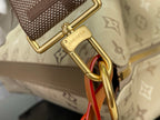 Gold hardware ring with strap attachment on beige monogram bag