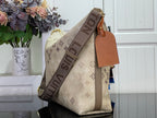 Beige monogram hobo shoulder bag with wide strap and tan leather luggage tag