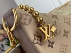 Gold chain strap and LV charm on beige monogram bag