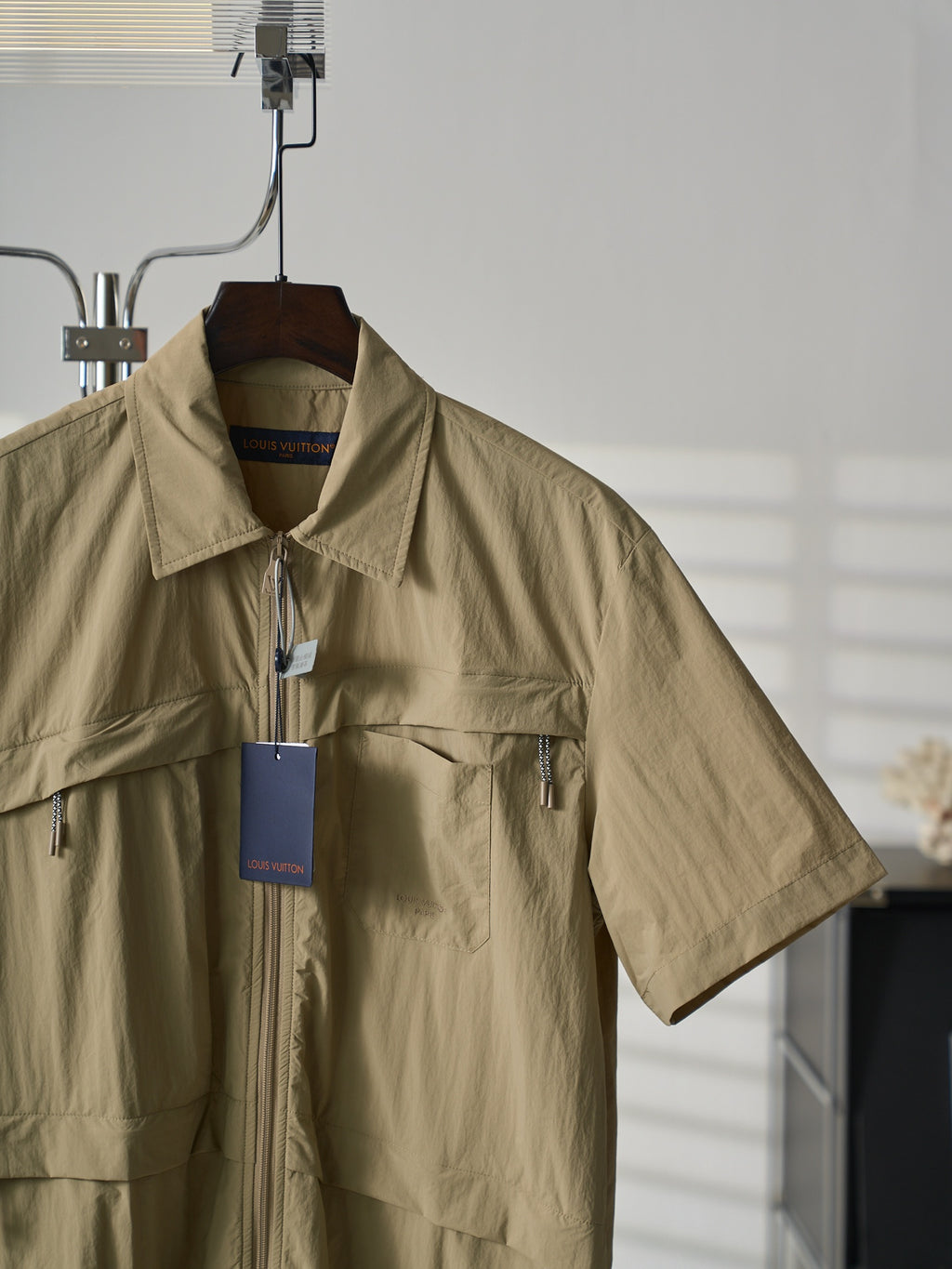 Louis Vuitton light tan short-sleeve shirt close-up, zip front and chest pocket