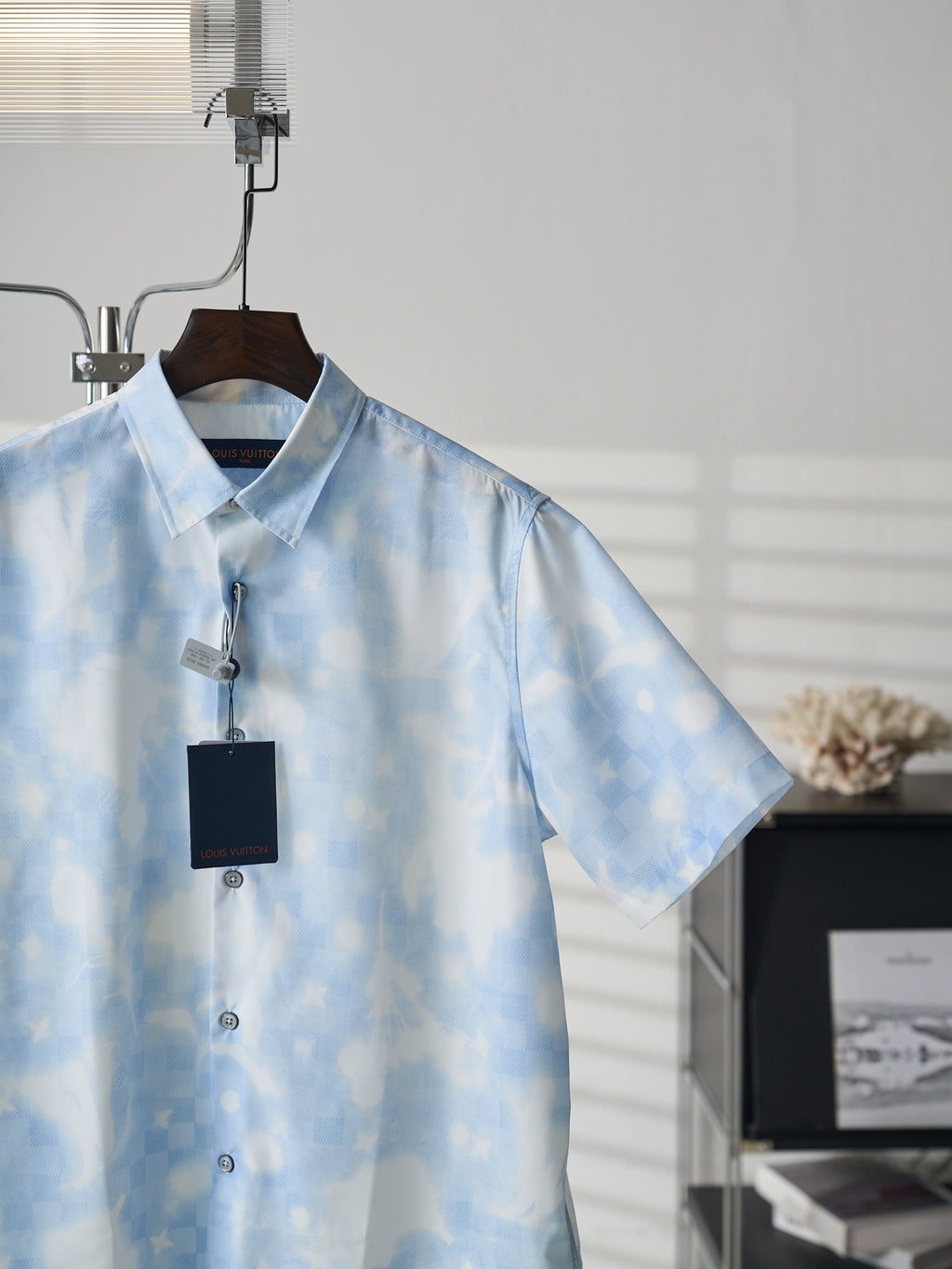 Louis Vuitton light blue short-sleeve button-up shirt with visible buttons and hang tag