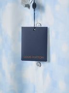 Louis Vuitton black hang tag on light blue short-sleeve shirt