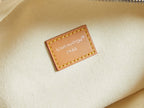 Louis Vuitton interior label on cream fabric lining with tan border stitching