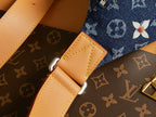 Louis Vuitton monogram denim pocket detail with tan leather tab and silver clasp