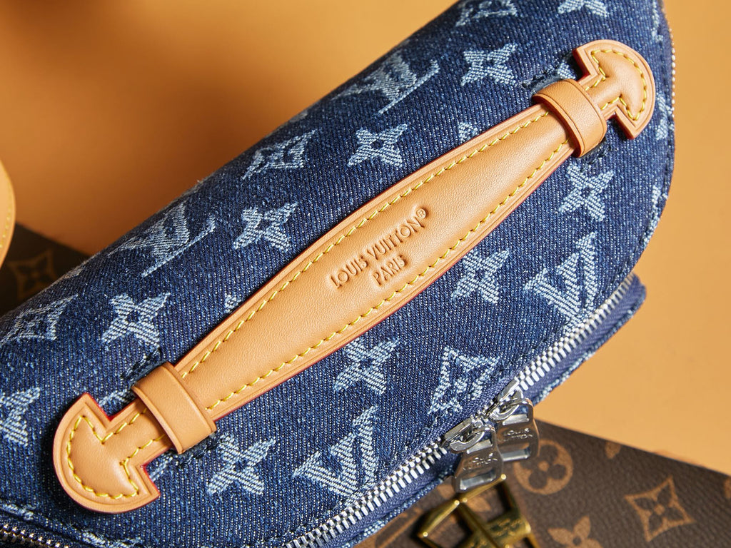 Louis Vuitton monogram denim strap with tan leather buckle and stitched edges