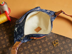 Louis Vuitton denim monogram bag interior with cream lining and leather brand tag
