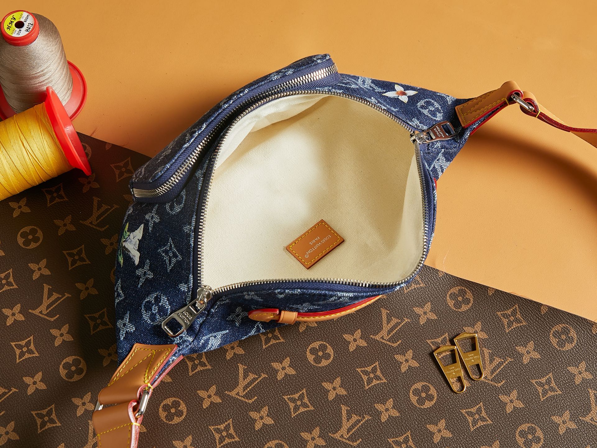 Louis Vuitton denim monogram bag interior with cream lining and leather brand tag