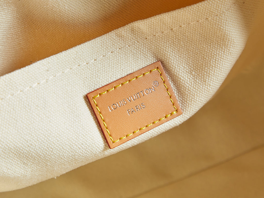 Louis Vuitton Paris leather label on off-white fabric interior