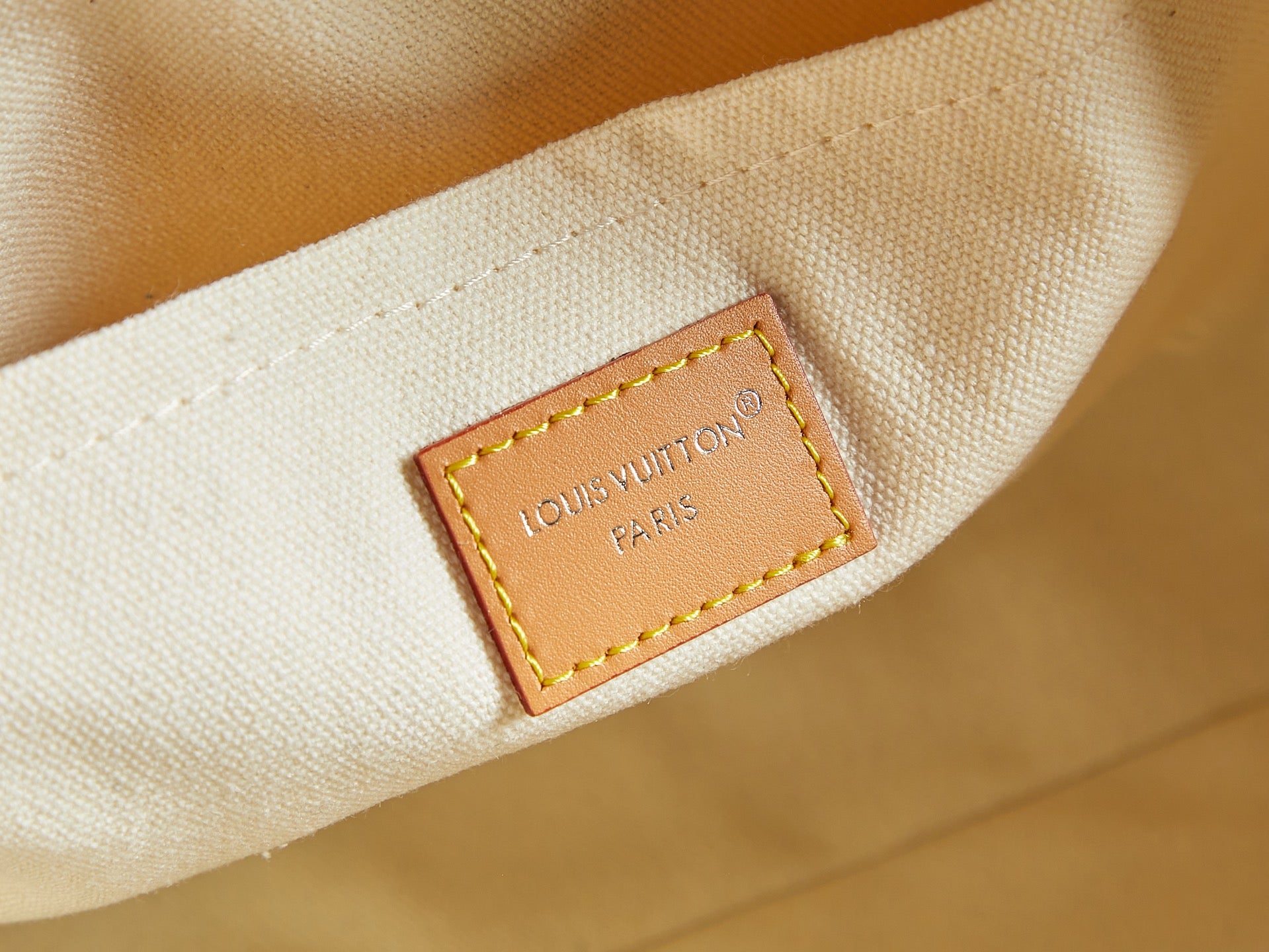 Louis Vuitton Paris leather label on off-white fabric interior