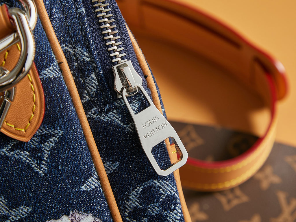 Louis Vuitton logo zipper pull and silver padlock charm on blue bag