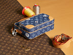 Louis Vuitton blue monogram bag with tan trim, zipper pull, and strap