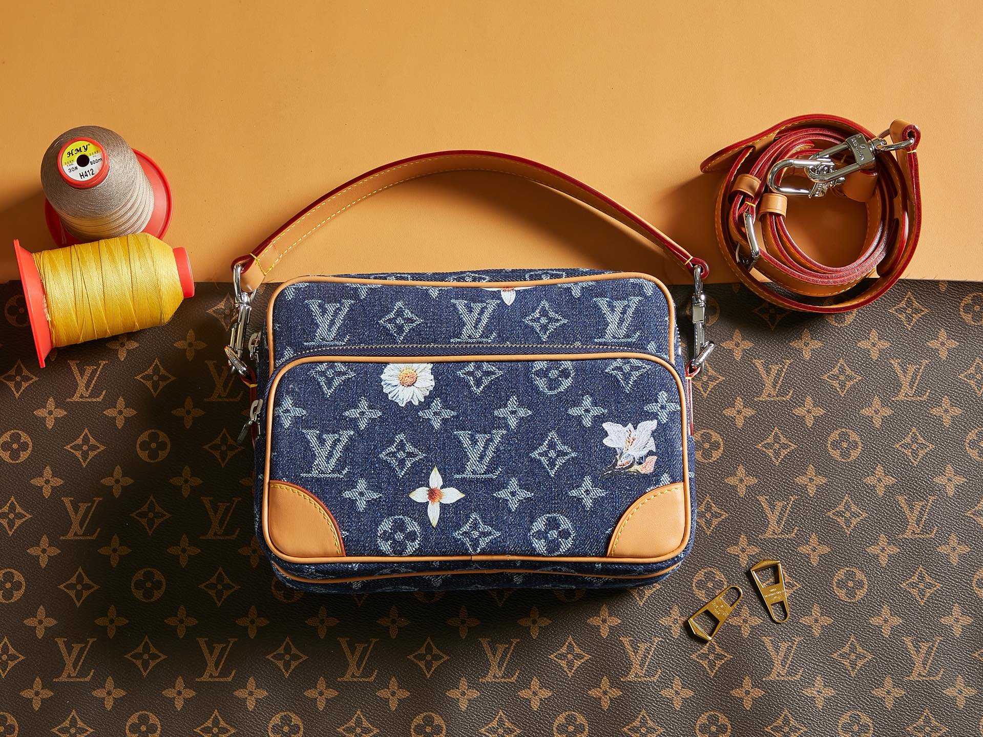 Louis Vuitton blue monogram crossbody bag with tan trim and top zip