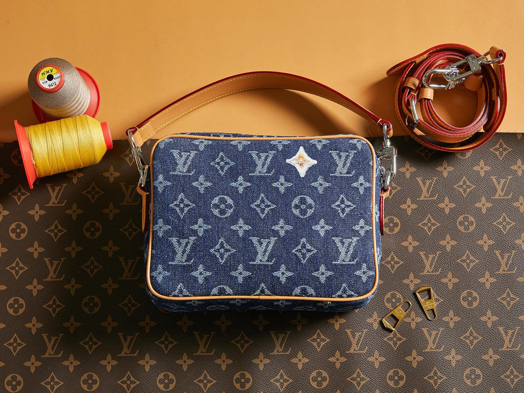 Louis Vuitton blue monogram crossbody bag with tan leather strap and top zip