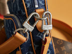Louis Vuitton bag hardware closeup with silver rings and tan leather tabs