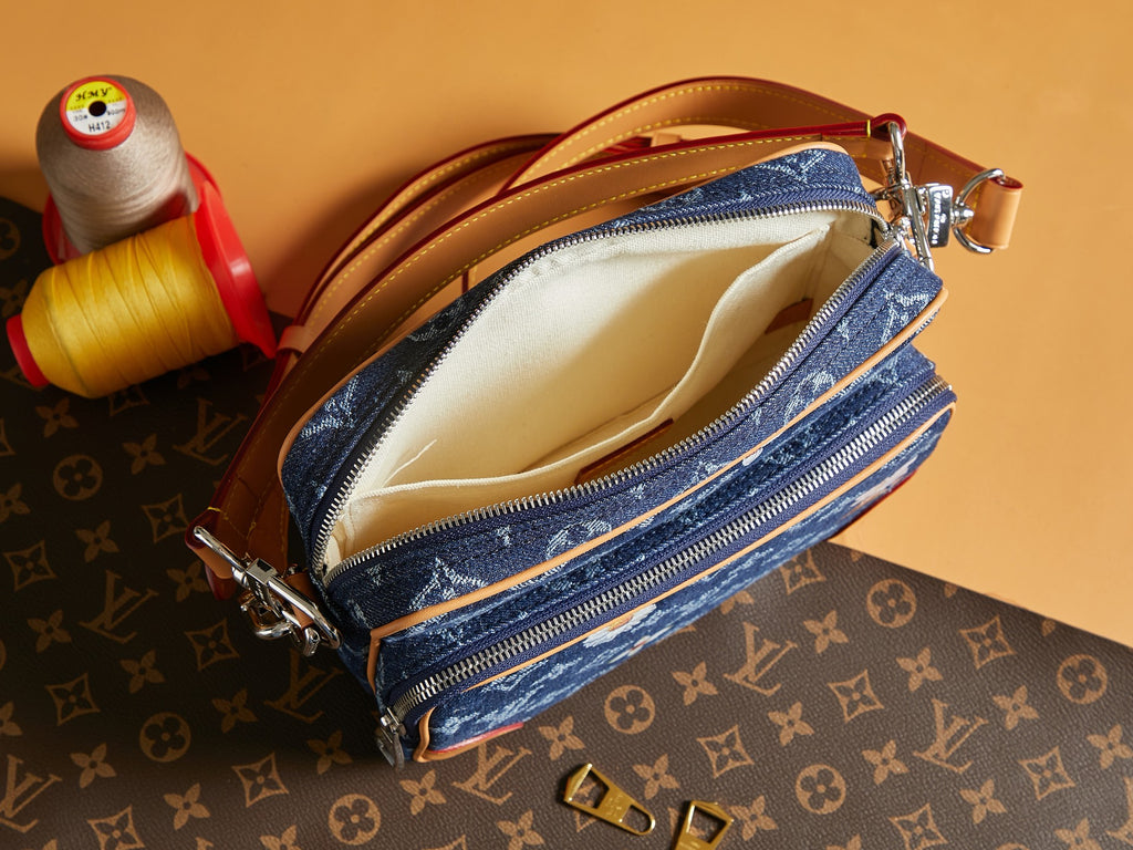 Louis Vuitton blue monogram crossbody bag open, showing tan fabric lining