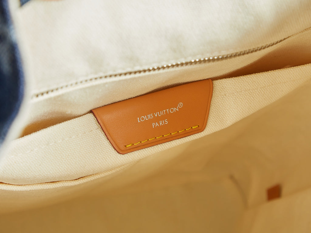 Close-up of duffel bag interior patch label with tan leather trim