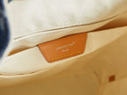 Close-up of duffel bag interior patch label with tan leather trim