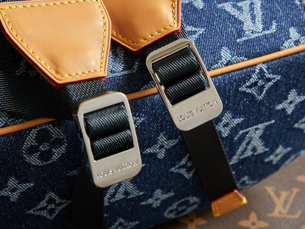 Close-up of duffel bag strap hardware with tan leather tabs