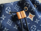 Close-up of duffel bag zipper pull with tan leather tab and star charm