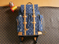 Blue monogram duffel bag with tan leather straps and top handles