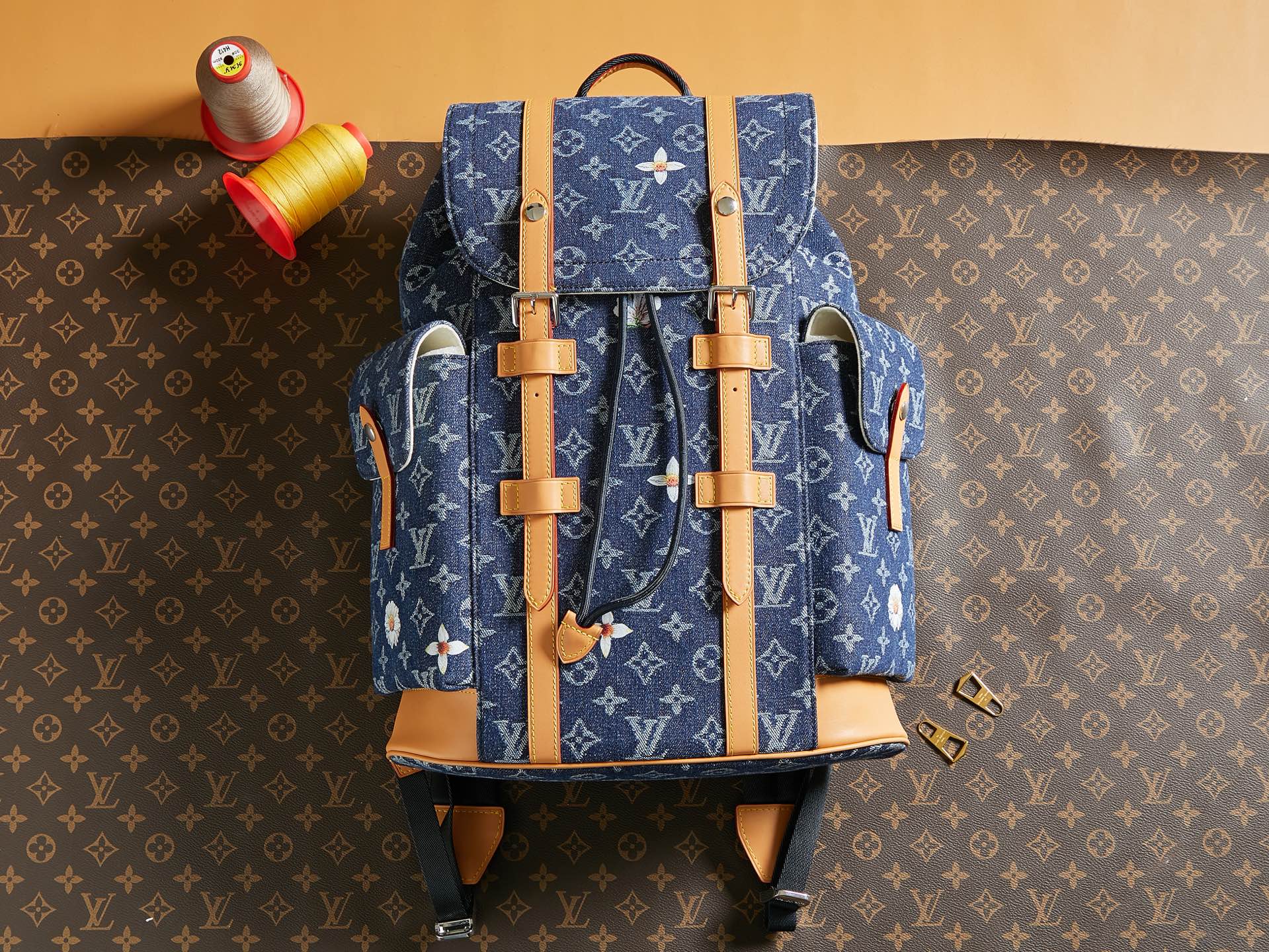 Blue monogram duffel bag with tan leather straps and top handles