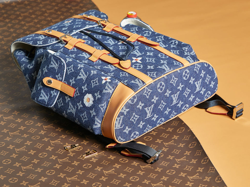Blue monogram duffel bag with tan leather straps and crossbody attachment