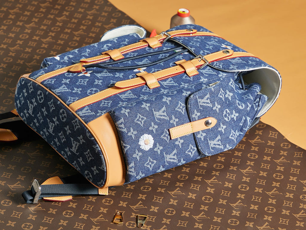 Blue monogram duffel bag with tan trim, top handles, and open interior