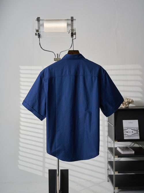 Short-sleeve button-up shirt in dark blue, back view on hanger